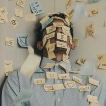 Person with post-it notes on face 