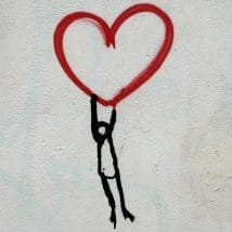 Stick person holding a heart
