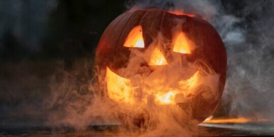 smoke surrounding jack-o-lantern who is so excited to read the october 2022 newsletter