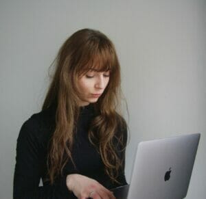 Girl working on apple laptop device