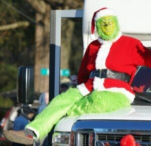 The Grinch sits on a truck waiting patiently for the December 2022 newsletter