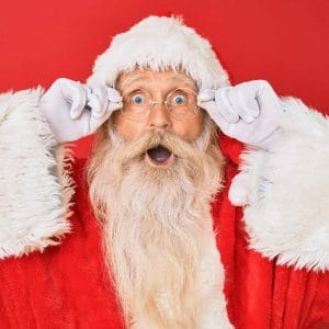 Santa holding his glasses in our December 2022 newsletter