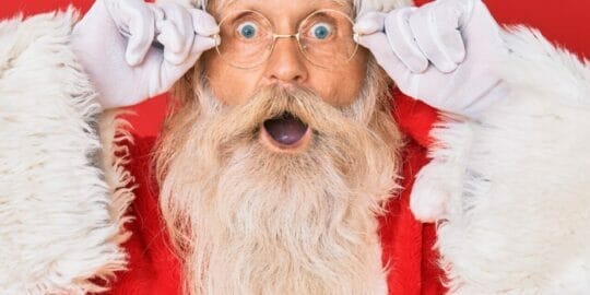 Santa Claus holding his glasses in our December 2022 newsletter