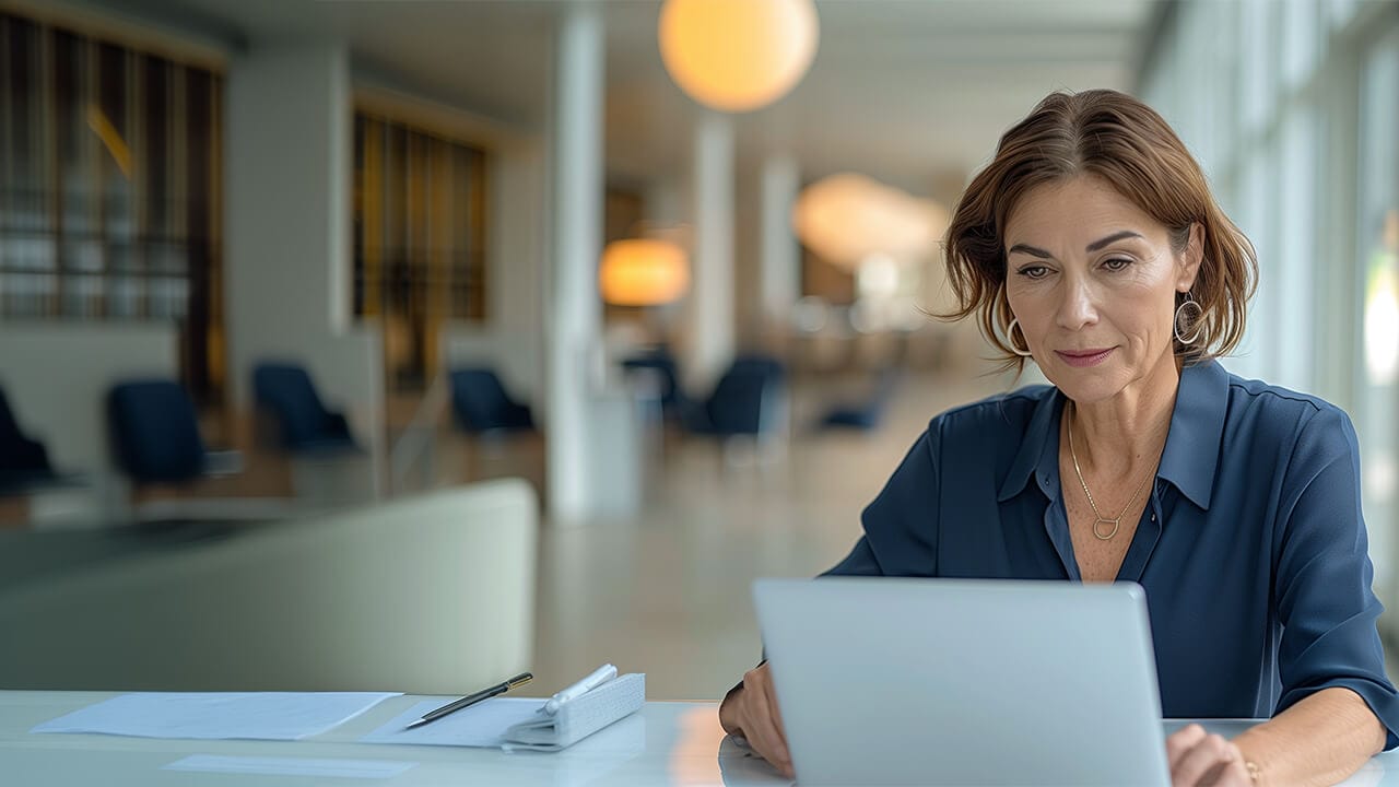f12.products.f12-connect.woman-iphone Female warehouse manager working on a laptop