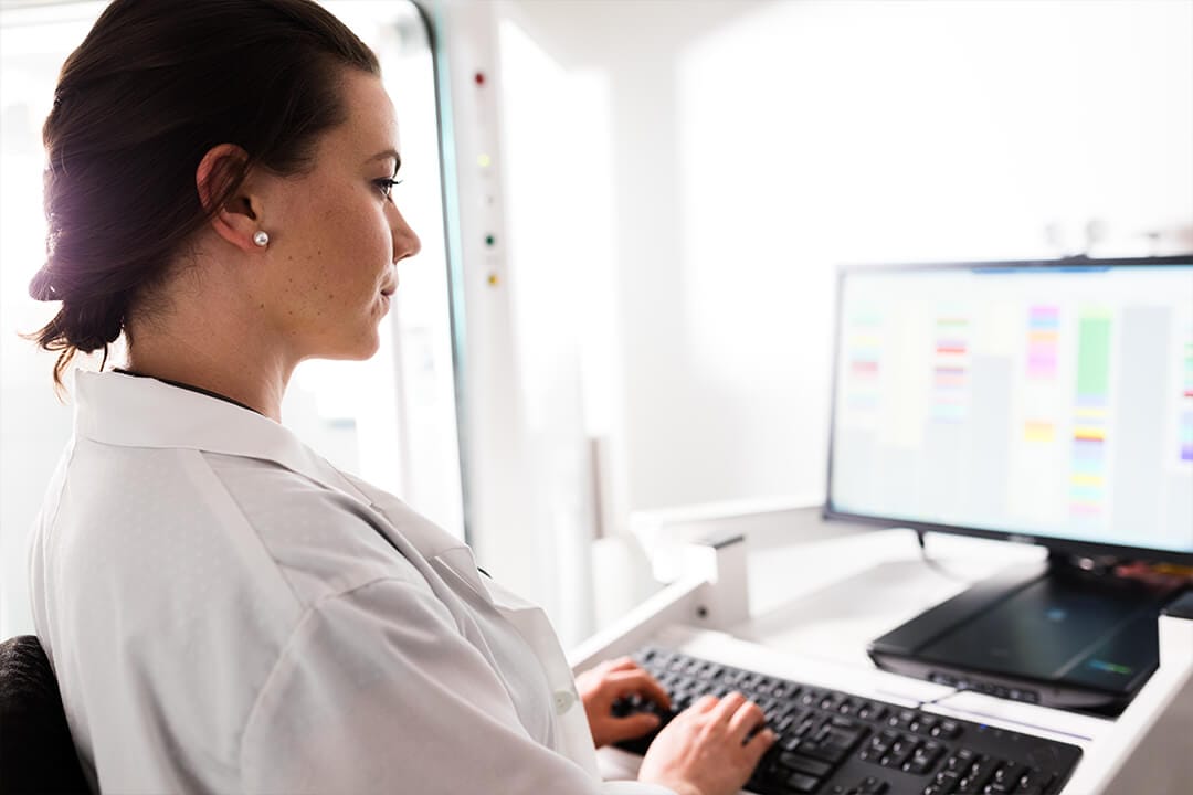 f12-co-managed-it-service.woman-desktop Female doctor working on a laptop at her office
