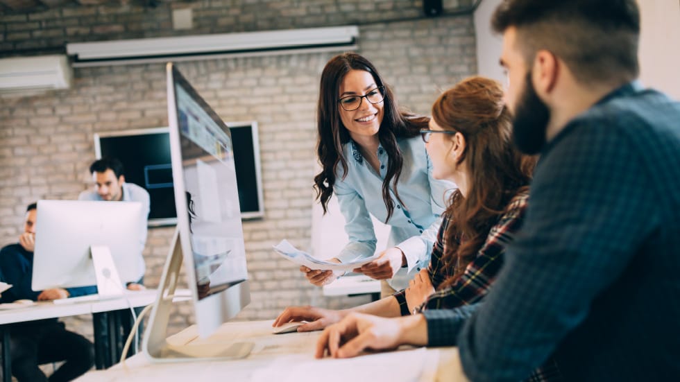 F12.Sovereign-Cloud-Services.people-office Female warehouse manager working on a laptop