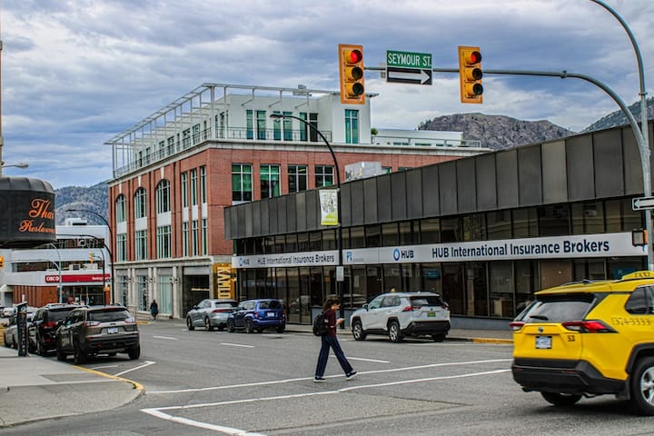 Woman walking down the street with a mobile device in Toronto, Canada