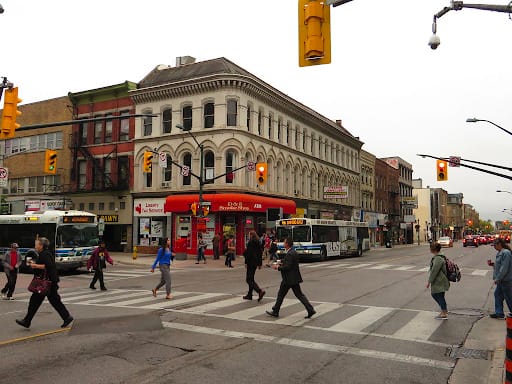 Woman walking down the street with a mobile device in Toronto, Canada