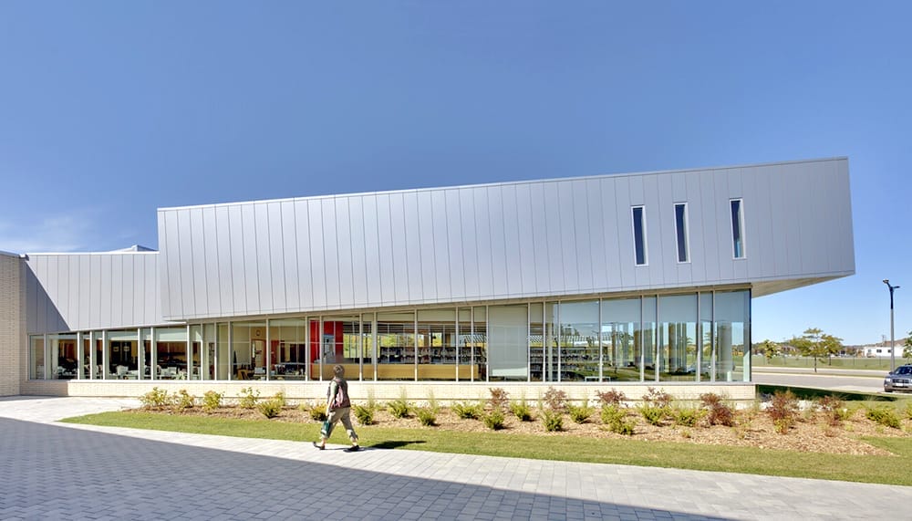Woman walking down the street with a mobile device in Toronto, Canada